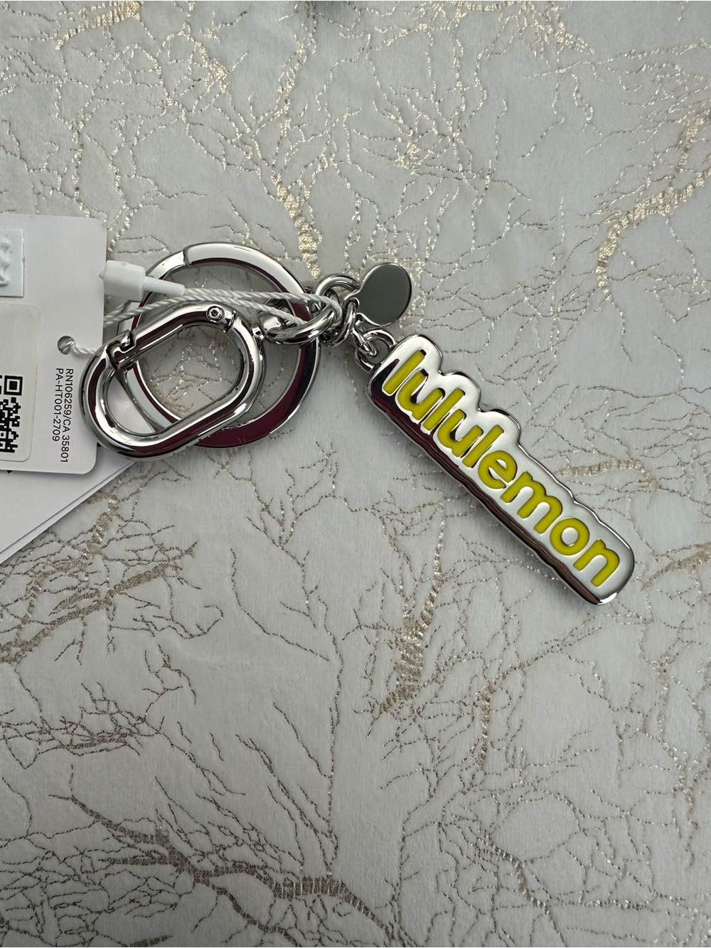 lululemon Silver Keychain with Yellow Logo